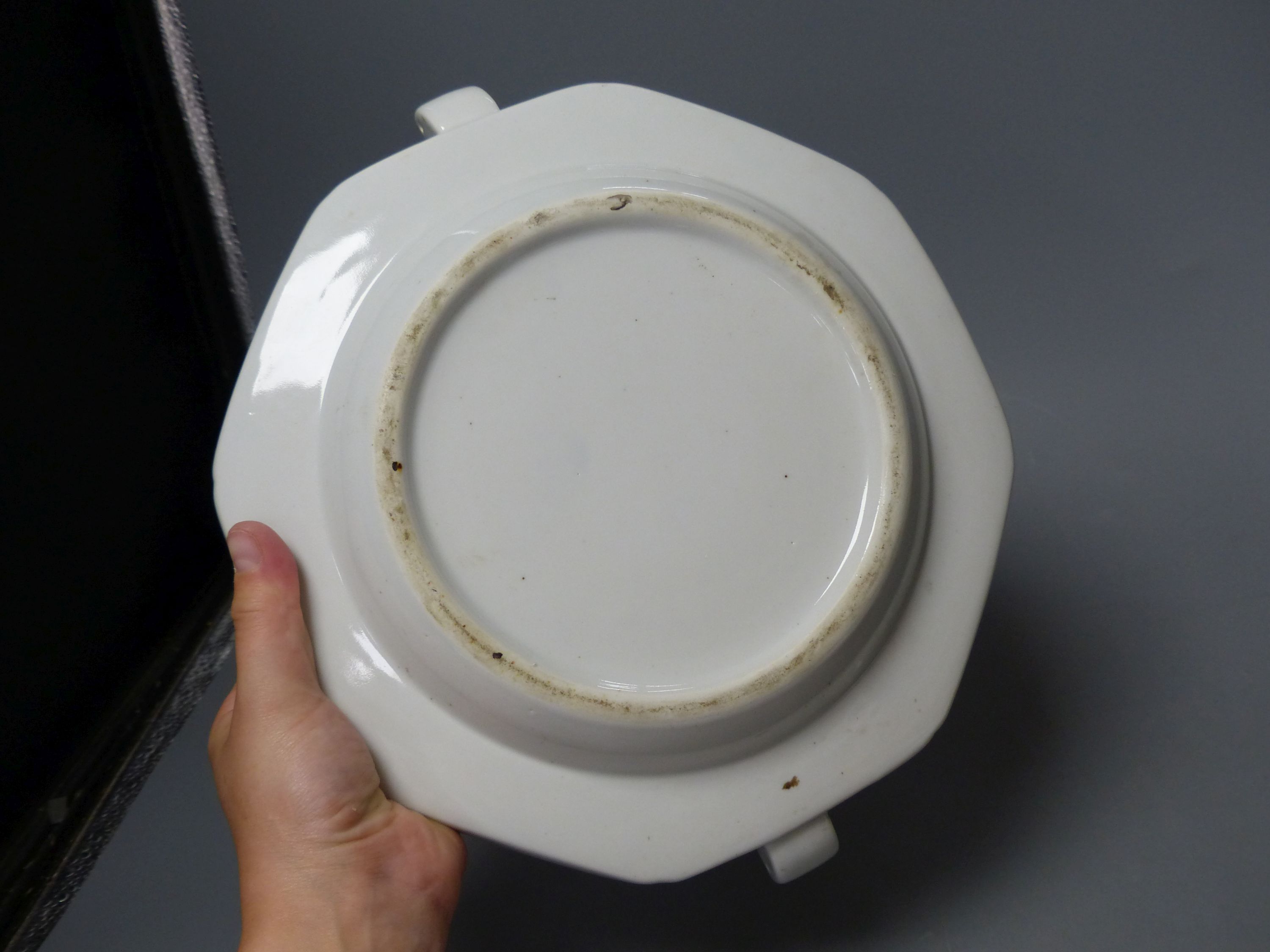A Chinese blue and white water pot and two sang de boeuf cups and a plate warmer